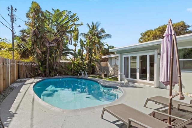 view of pool with a patio and french doors