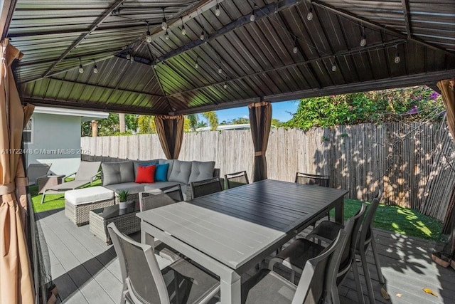 wooden terrace with a gazebo and outdoor lounge area