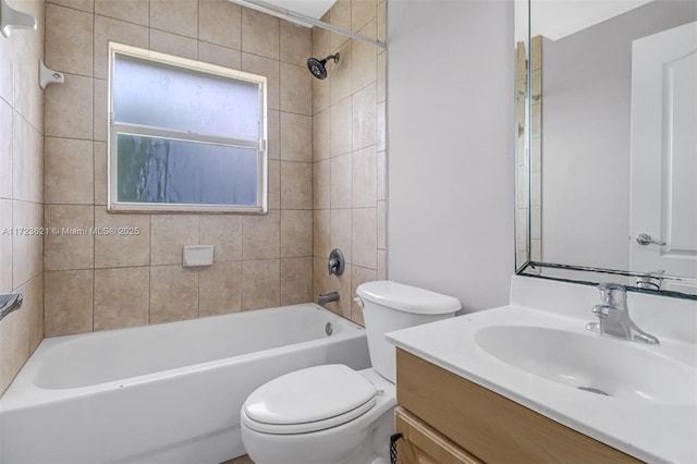 full bathroom with tiled shower / bath combo, toilet, and vanity