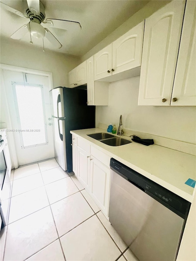 kitchen featuring dishwasher, white cabinets, light tile patterned flooring, and sink