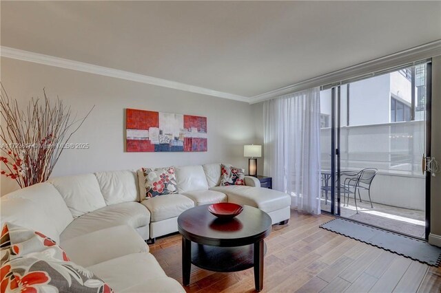 living room featuring hardwood / wood-style floors, a chandelier, and ornamental molding