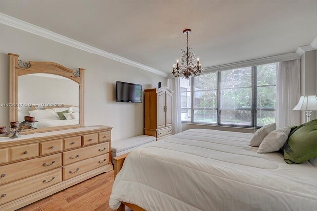 bedroom featuring a chandelier, light hardwood / wood-style floors, and ornamental molding