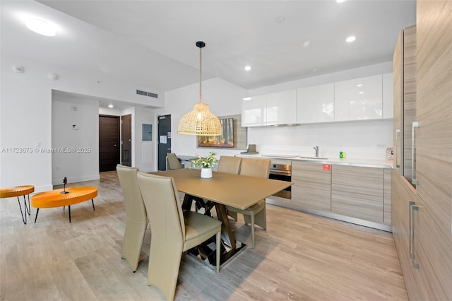 dining area featuring sink and light hardwood / wood-style flooring