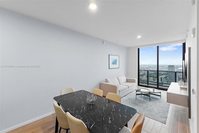 dining room featuring light hardwood / wood-style floors and floor to ceiling windows