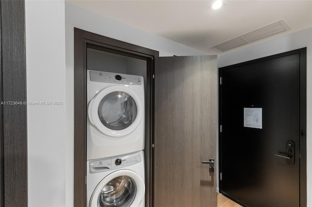 laundry room with stacked washer and clothes dryer