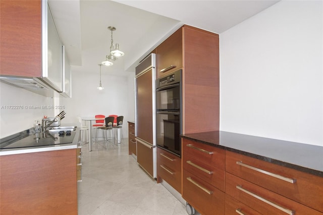 kitchen featuring black appliances, sink, and pendant lighting