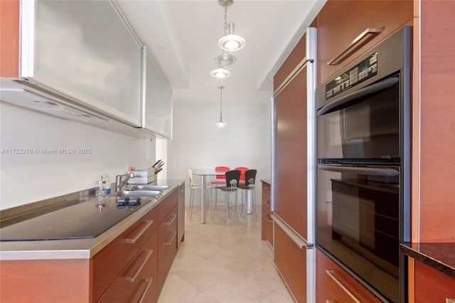 kitchen with sink, hanging light fixtures, and black appliances