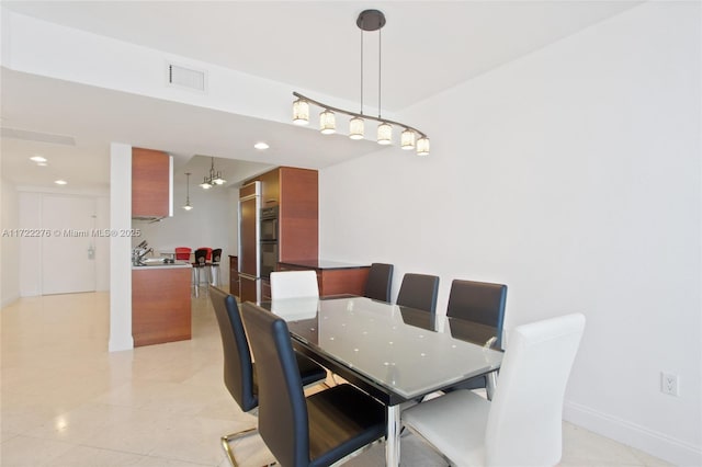 dining area with sink and light tile patterned floors