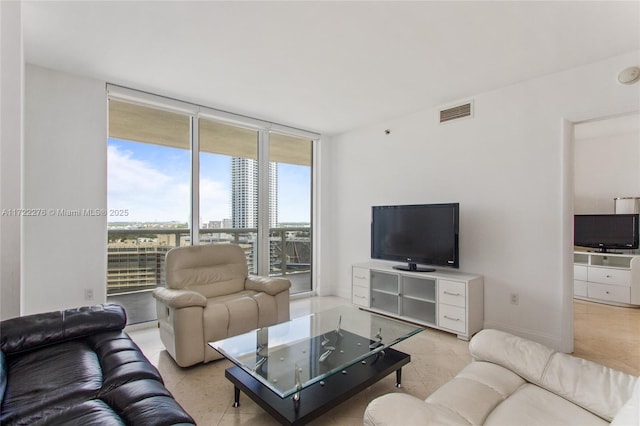 tiled living room with a wall of windows