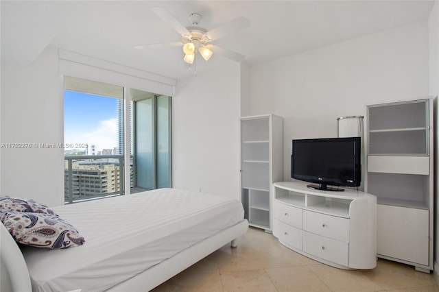 bedroom featuring ceiling fan and expansive windows