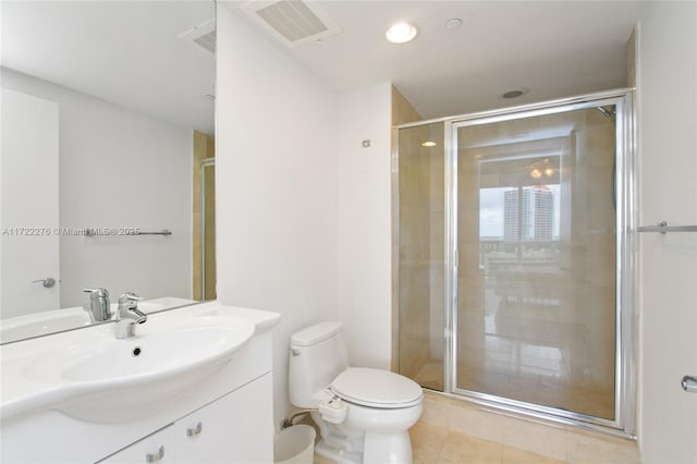 bathroom featuring tile patterned flooring, vanity, a shower with shower door, and toilet