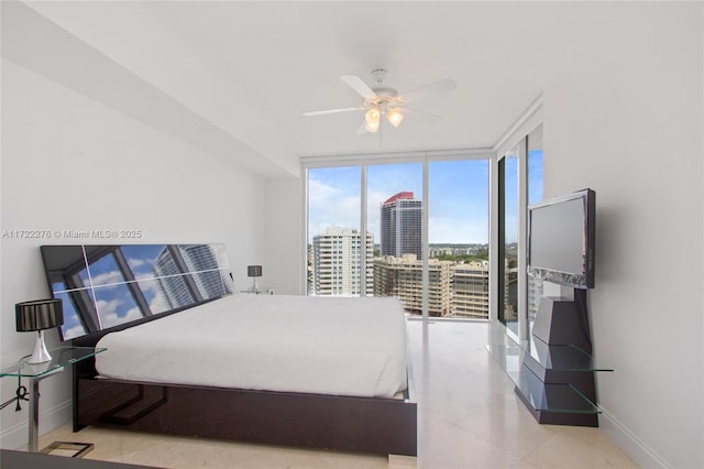 bedroom with floor to ceiling windows and ceiling fan