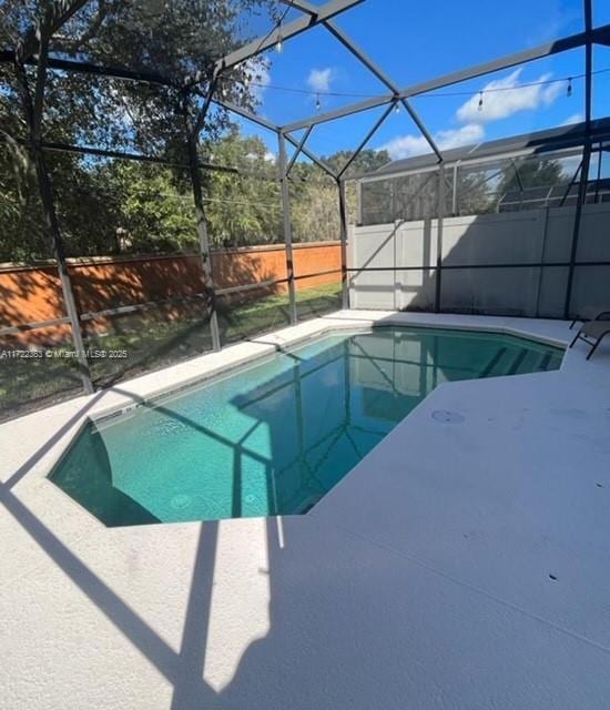 view of pool with a patio area and a lanai