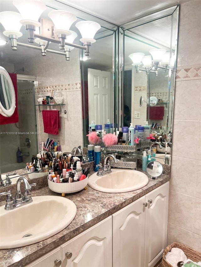 bathroom with vanity, tile walls, and walk in shower