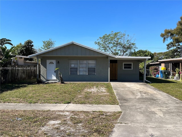 view of front of property with a carport and a front lawn