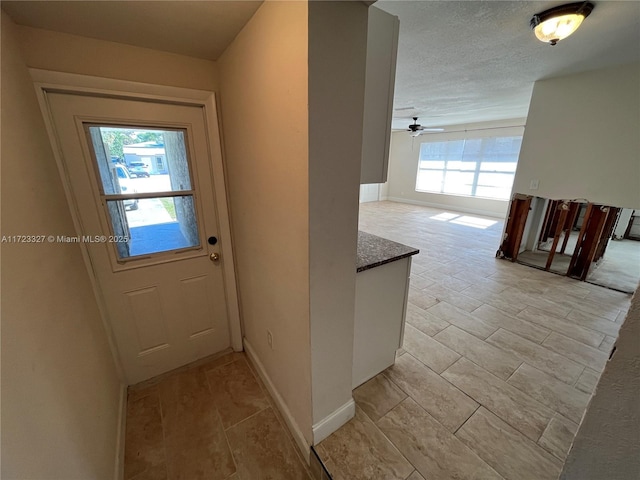 doorway to outside featuring plenty of natural light and ceiling fan