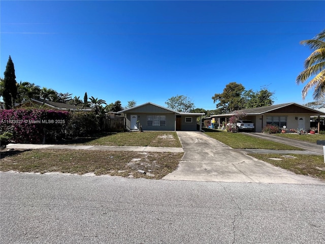 ranch-style home with a front lawn and a carport