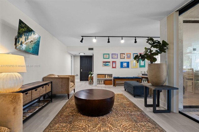 kitchen with white cabinetry, sink, stainless steel appliances, and light wood-type flooring