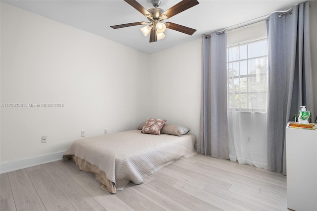 bedroom with light hardwood / wood-style flooring and ceiling fan