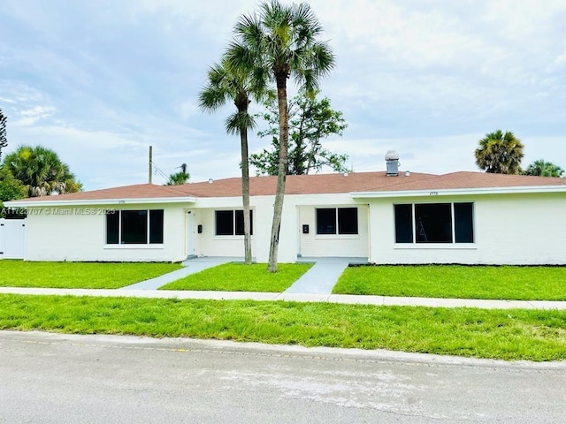 ranch-style home featuring a front yard