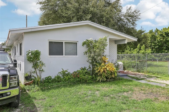 view of side of property with a yard