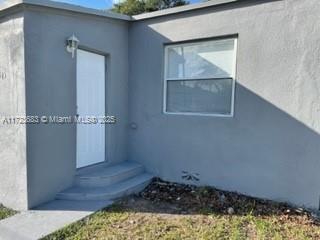 doorway to property with stucco siding