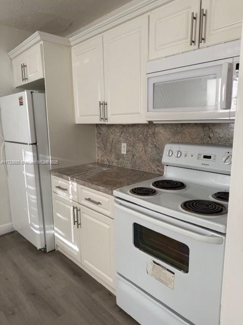 1545 NW 68st, Miami, FL 33147 - kitchen featuring dark wood finished floors, white cabinets, white appliances, and tasteful backsplash