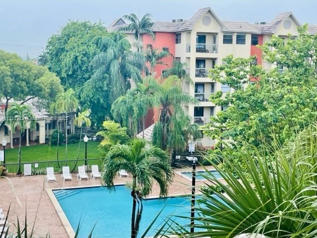 8290 Lake Dr Unit 235, Doral, FL 33166 - community pool with fence and a patio area