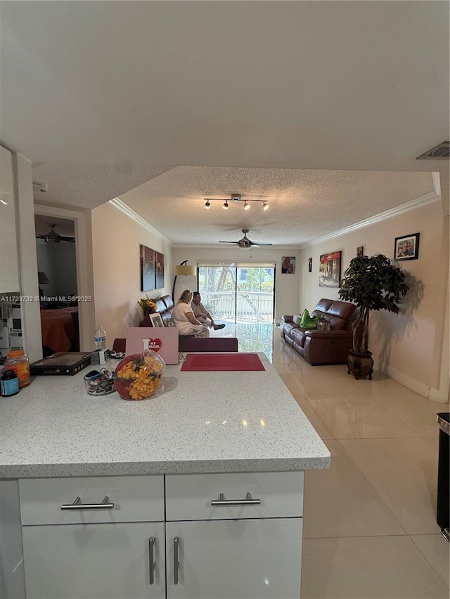 8290 Lake Dr Unit 235, Doral, FL 33166 - kitchen featuring ornamental molding, open floor plan, ceiling fan, a textured ceiling, and light tile patterned floors