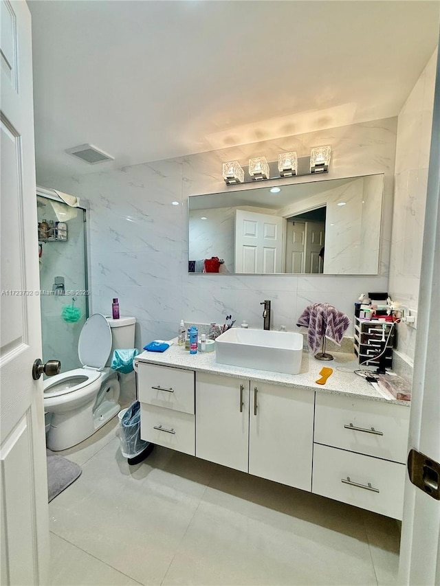 8290 Lake Dr Unit 235, Doral, FL 33166 - bathroom featuring tile walls, toilet, vanity, a stall shower, and tile patterned floors