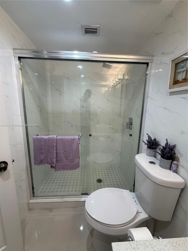 8290 Lake Dr Unit 235, Doral, FL 33166 - bathroom featuring toilet, a stall shower, and tile walls