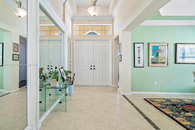 tiled entryway featuring ornamental molding