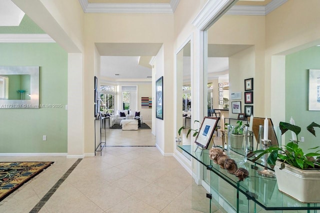 hall with crown molding and light tile patterned floors