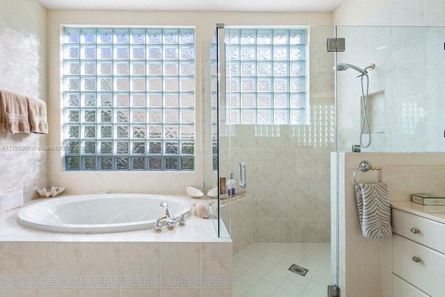 bathroom featuring vanity, a healthy amount of sunlight, and shower with separate bathtub