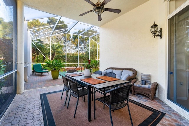 view of patio / terrace with ceiling fan and a lanai