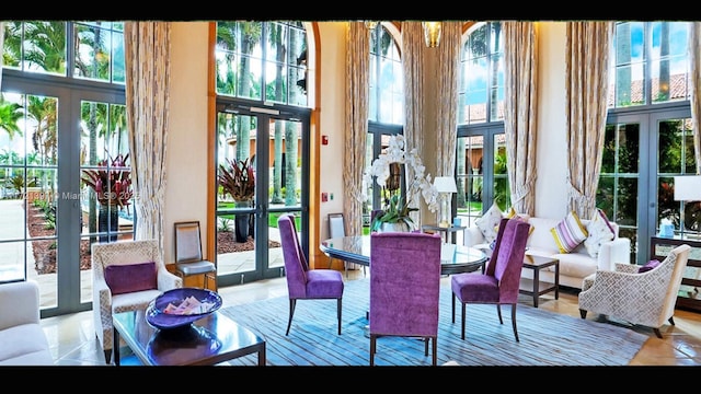 dining space with a towering ceiling and french doors