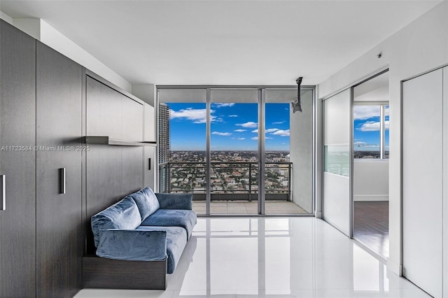 tiled living room featuring expansive windows