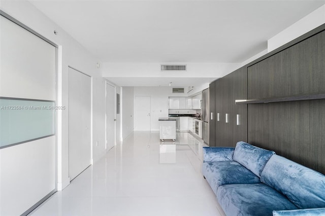 hallway with light tile patterned flooring