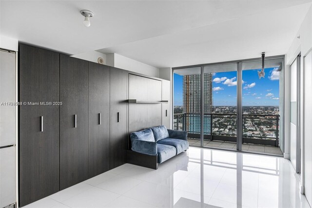 tiled bedroom with a wall of windows