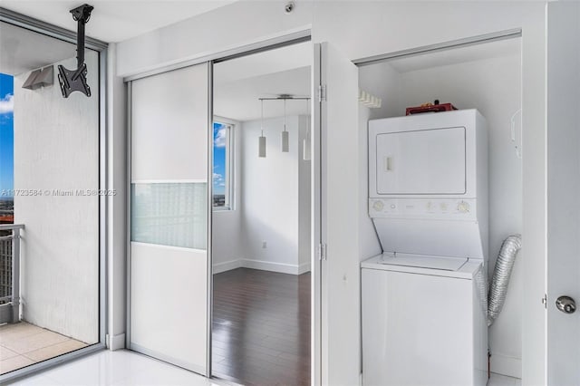 laundry area with stacked washer / drying machine