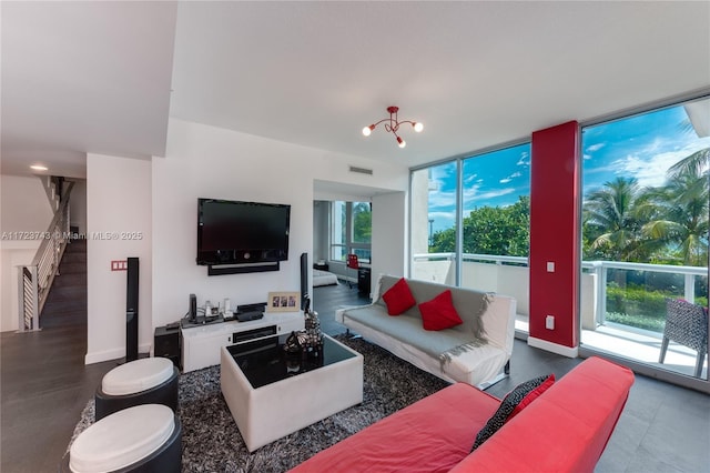 living room with expansive windows and a chandelier