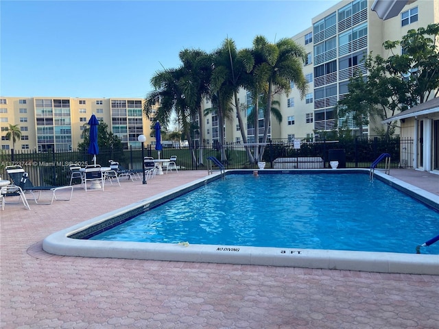 view of swimming pool featuring a patio area