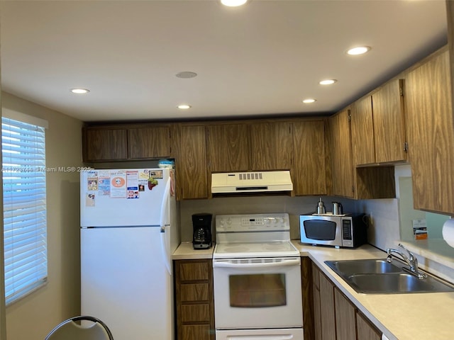 kitchen featuring sink and white appliances