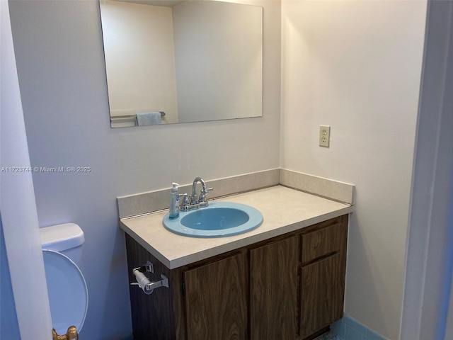 bathroom with toilet and vanity