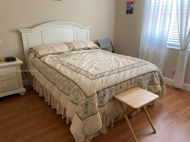 bedroom with hardwood / wood-style floors