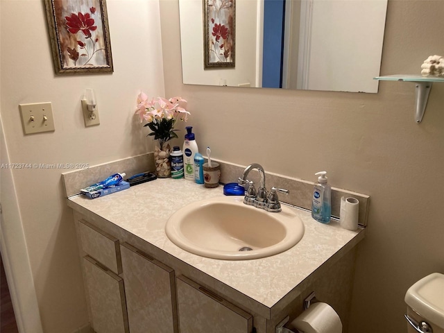 bathroom featuring toilet and vanity