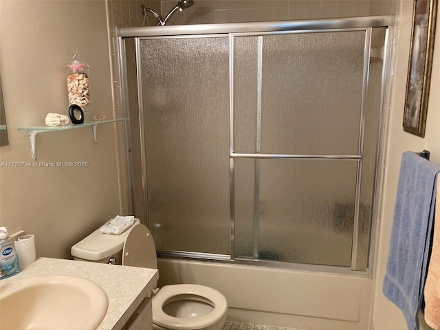 full bathroom featuring toilet, vanity, and enclosed tub / shower combo