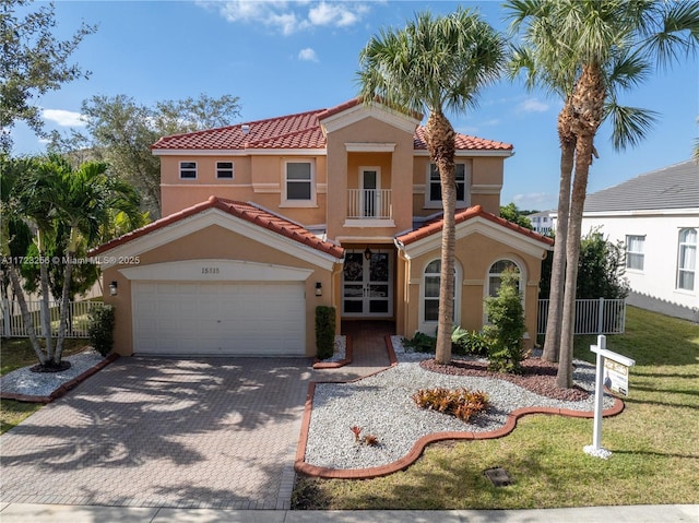 mediterranean / spanish-style house featuring a balcony and a front lawn