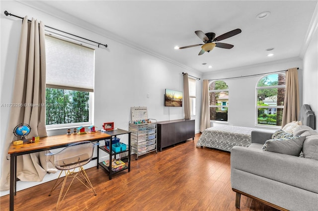 bedroom with multiple windows, ceiling fan, wood-type flooring, and ornamental molding