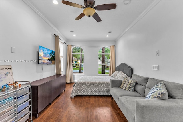 bedroom featuring dark hardwood / wood-style flooring, ceiling fan, and ornamental molding